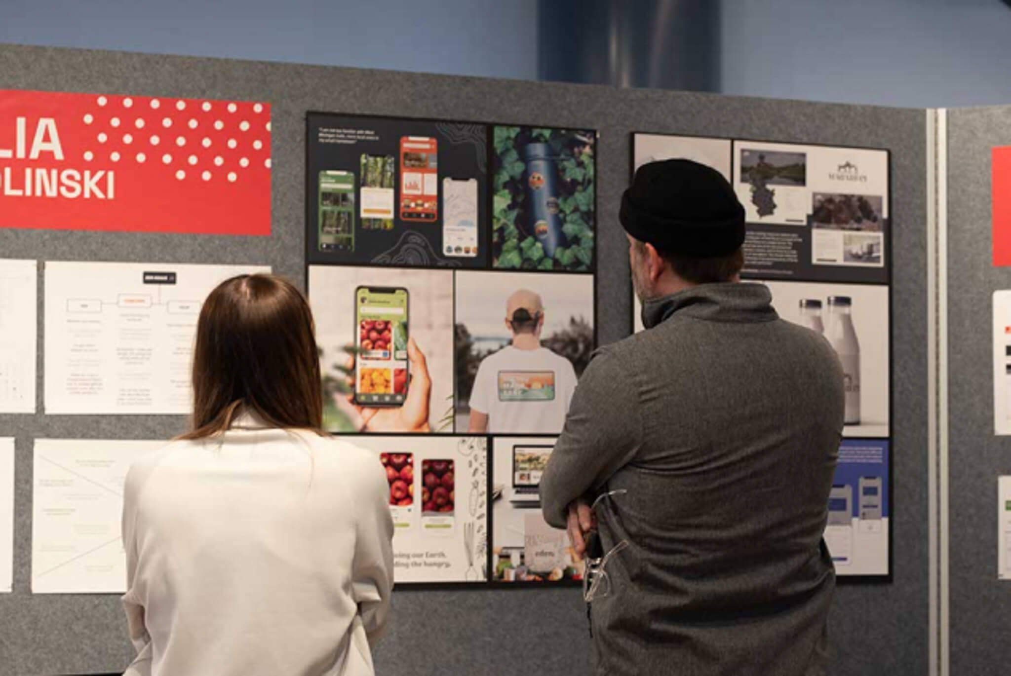 People from the back looking at a wall of  design work